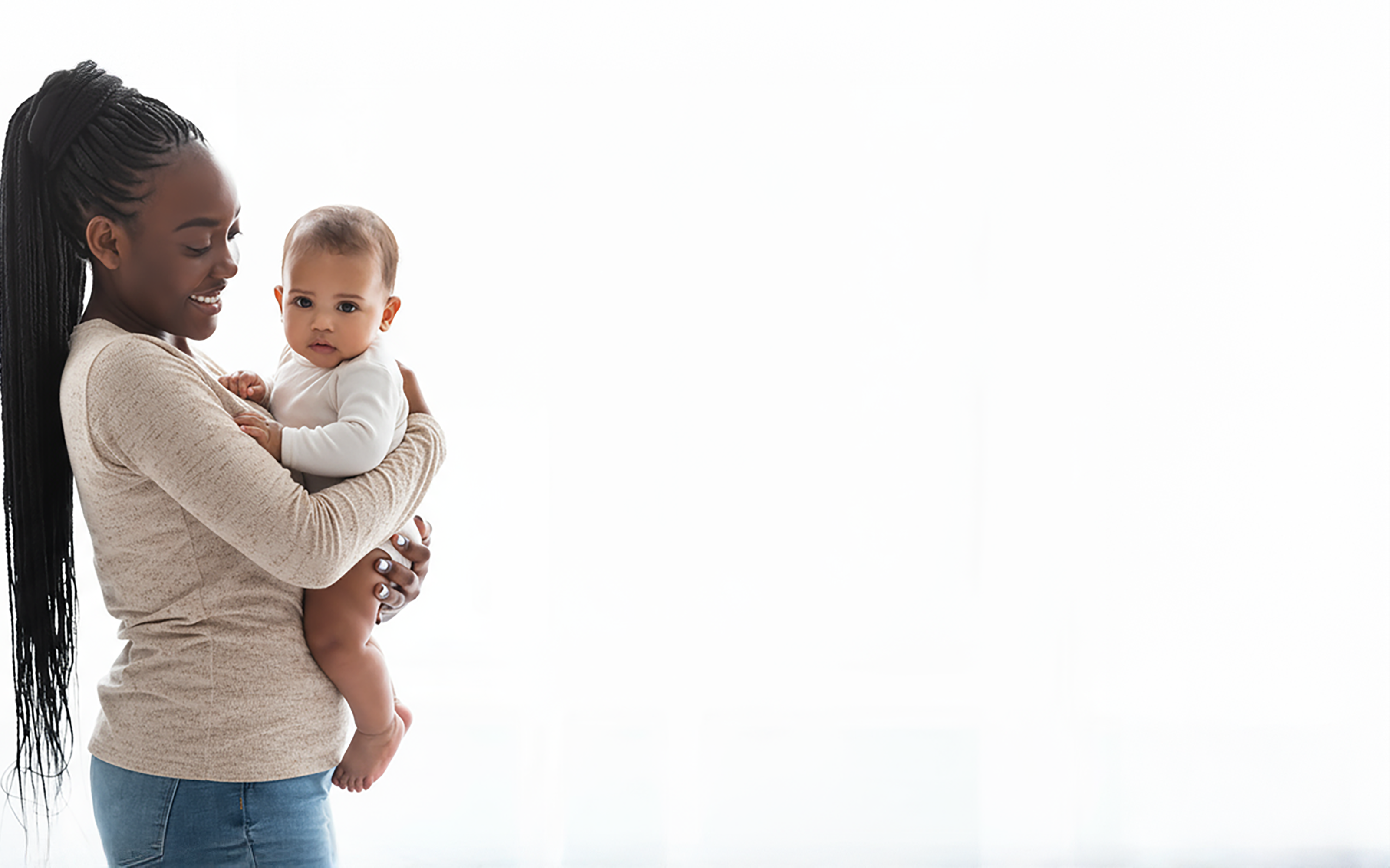 Woman holding a baby against a white background
